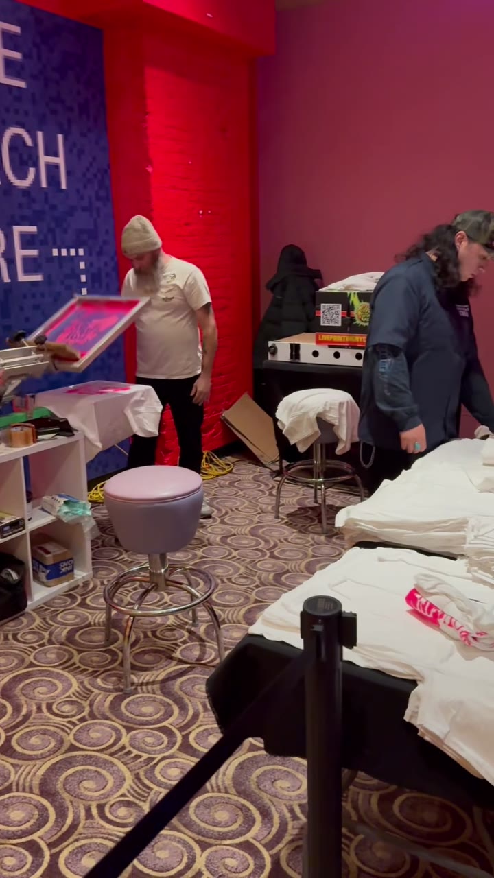 The crew screen printing tees live at the Supreme merch activation, stacks of shirts ready to print