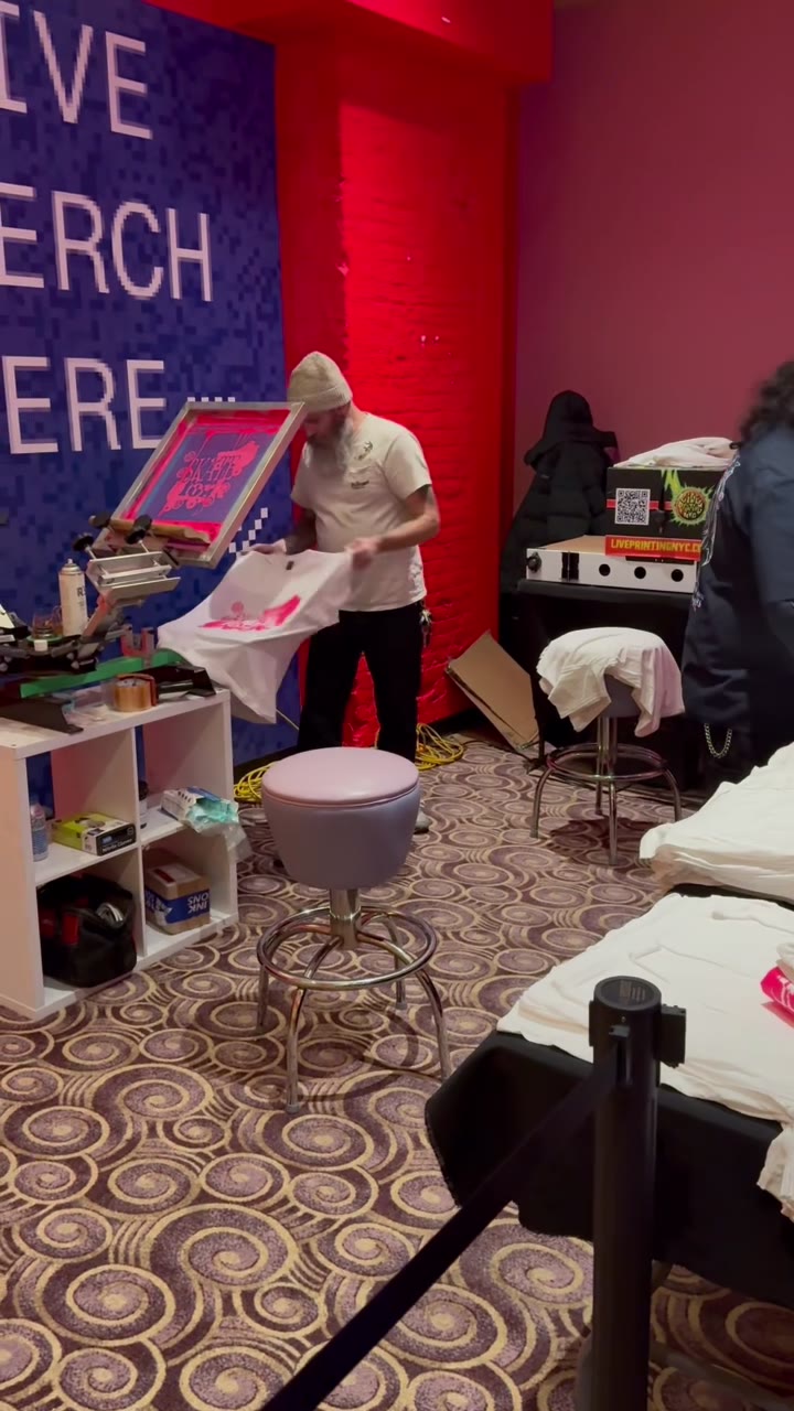A freshly printed tee coming off the press at the Supreme live merch activation
