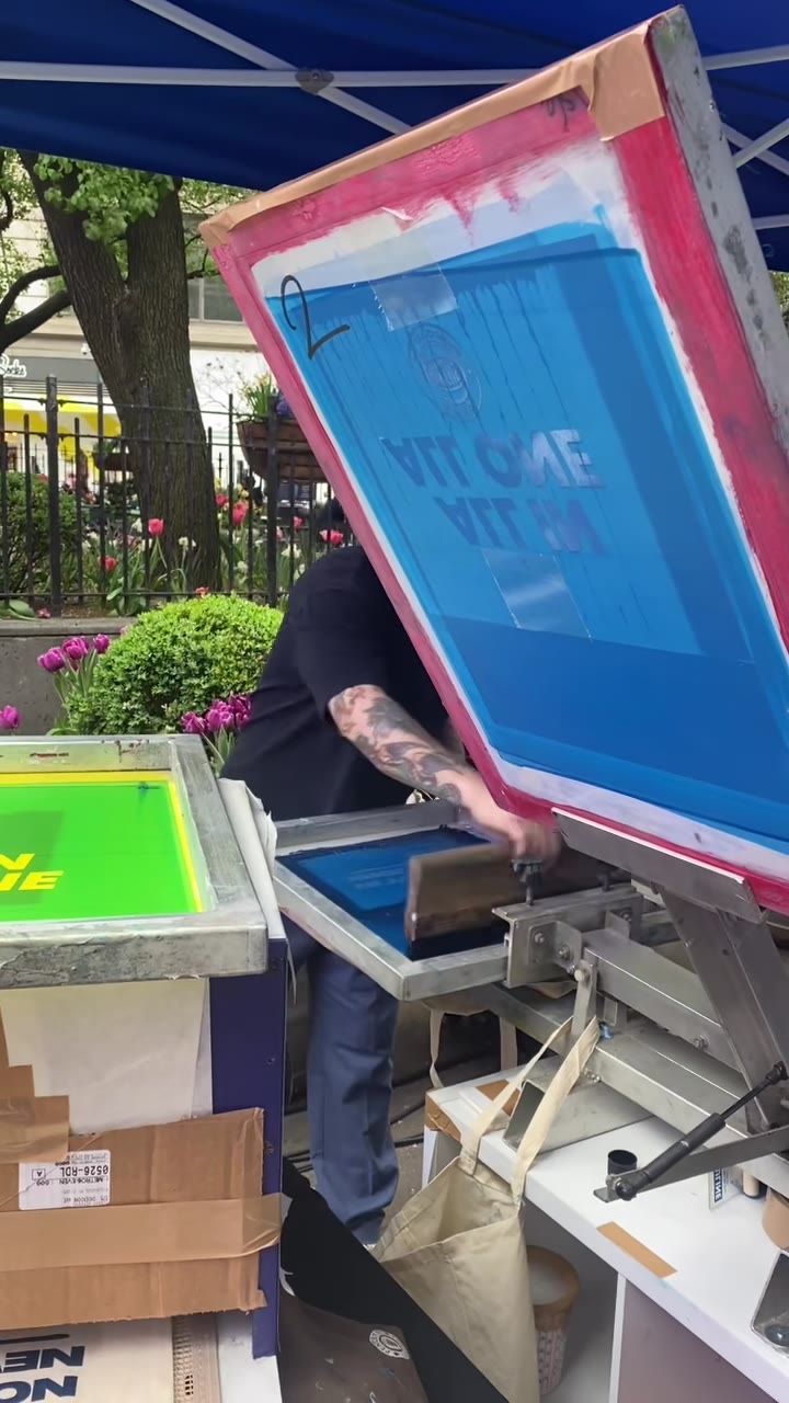 A squeegee pull in progress at the outdoor Knicks tent setup, crowd gathered around the table