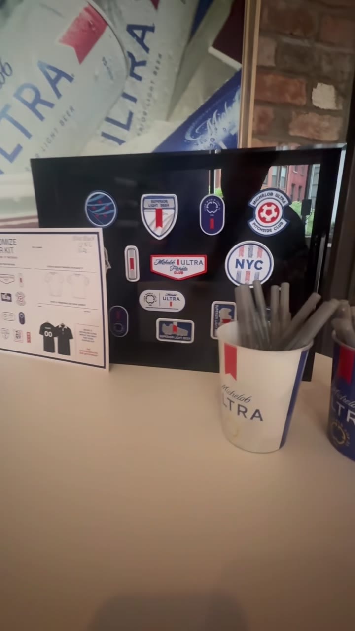 The patch and sticker selection board at the booth, Michelob Ultra designs laid out next to the kit customization menu