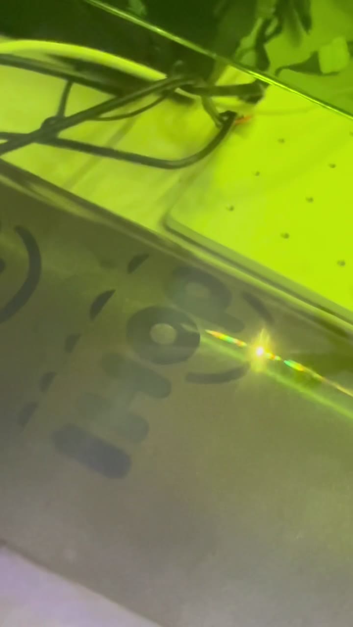 Macro of the laser beam etching lettering under the green lid
